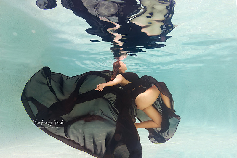 underwater fine art portraits in pool of woman in flowing black dress