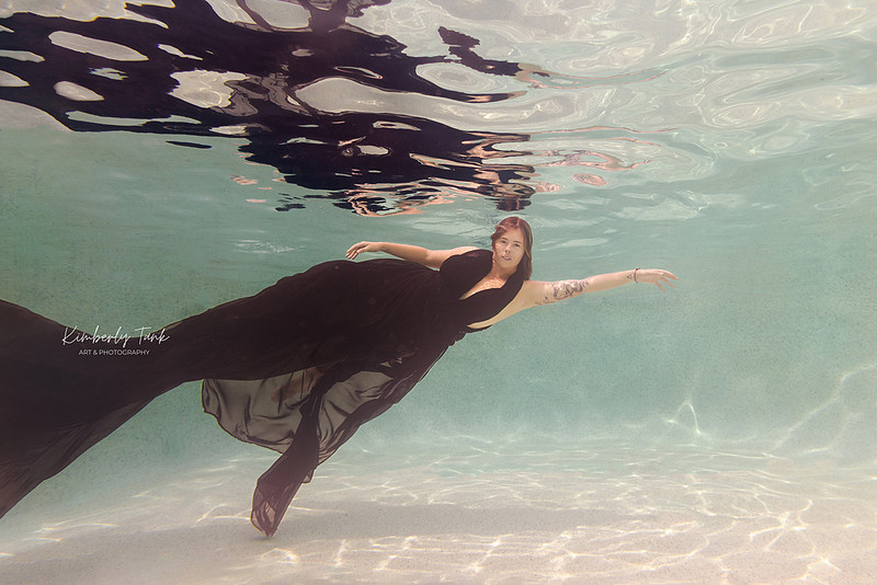 underwater fine art portraits in pool of woman in flowing black dress