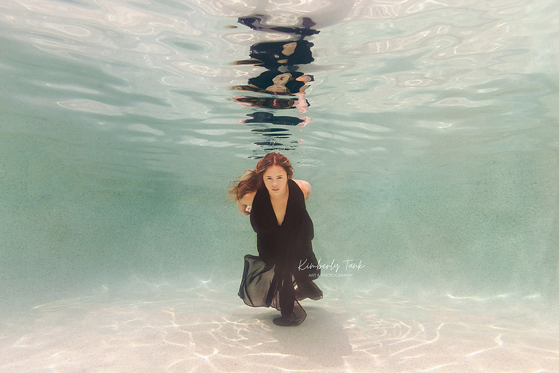 underwater fine art portraits in pool of woman in flowing black dress