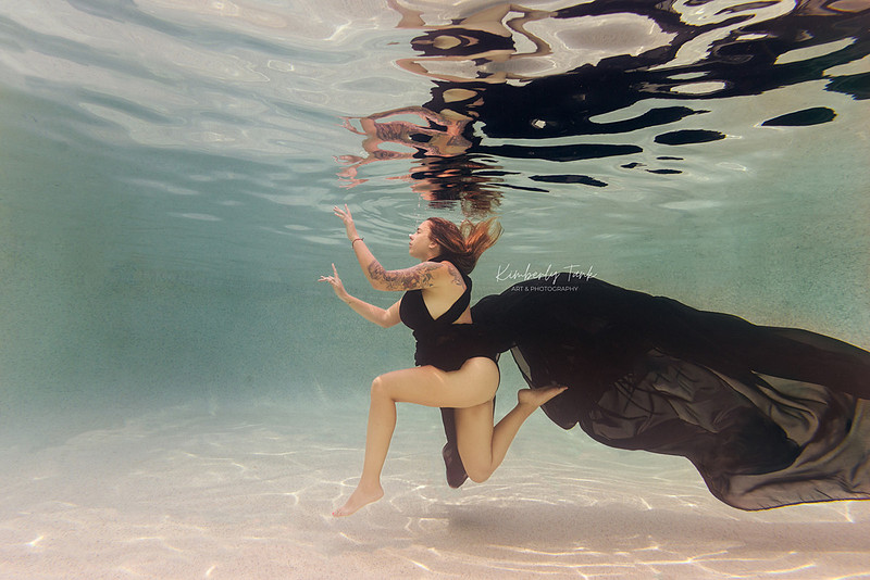 underwater fine art portraits in pool of woman in flowing black dress