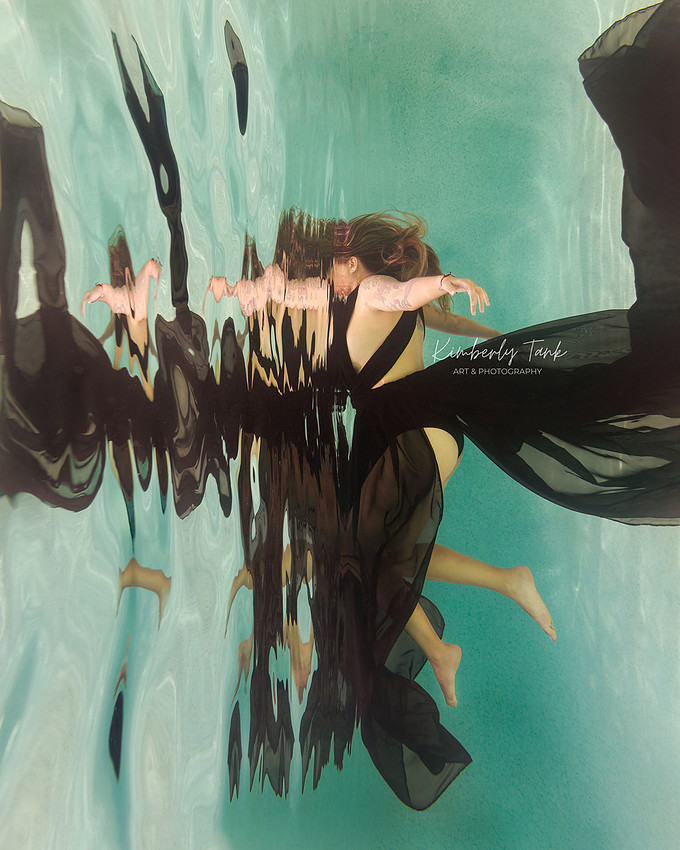 underwater fine art portraits in pool of woman in flowing black dress