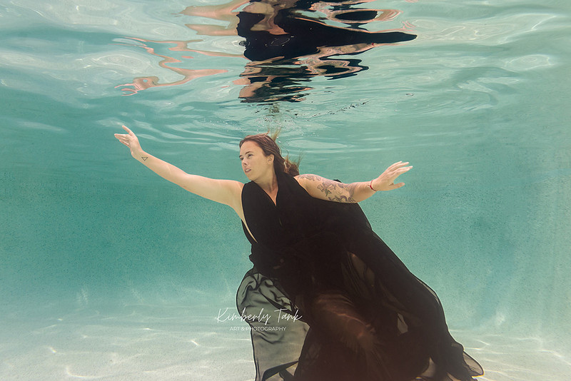 underwater fine art portraits in pool of woman in flowing black dress