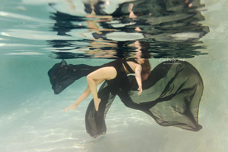 underwater fine art portraits in pool of woman in flowing black dress