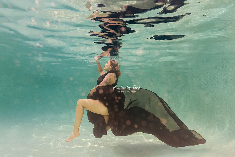 underwater fine art portraits in pool of woman in flowing black dress