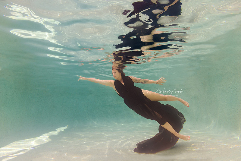 underwater fine art portraits in pool of woman in flowing black dress