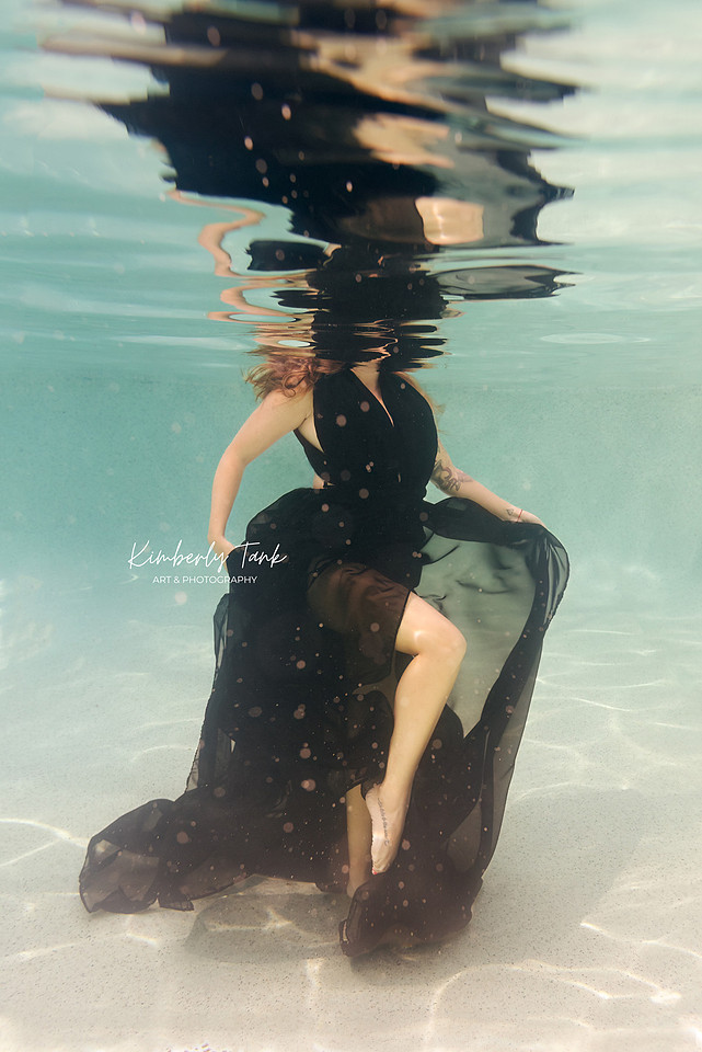 underwater fine art portraits in pool of woman in flowing black dress