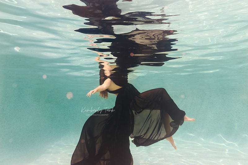 underwater fine art portraits in pool of woman in flowing black dress