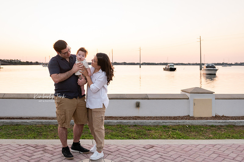 6 month old baby smiling big with mom at sunrise
