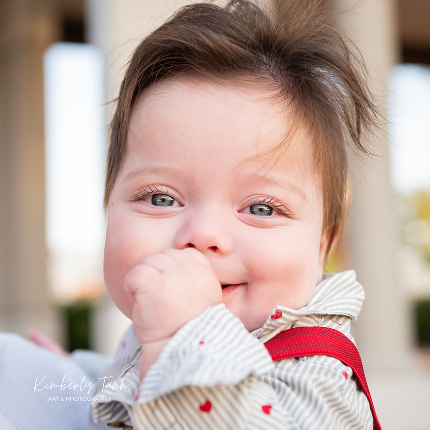 6 month old baby smiling big with mom at sunrise