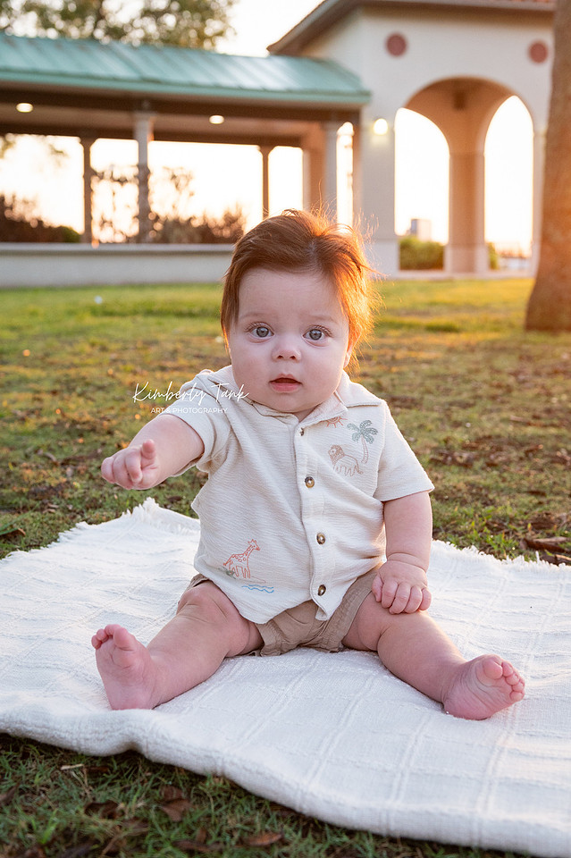 6 month old baby smiling big with mom at sunrise