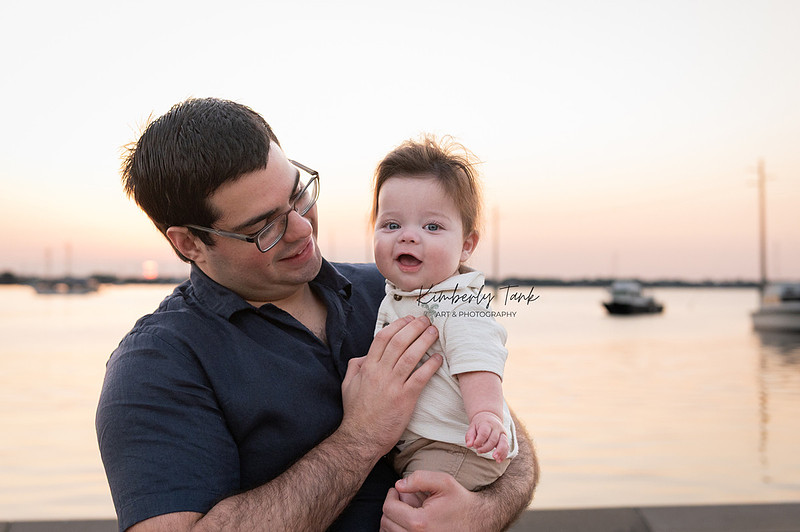 6 month old baby smiling big with mom at sunrise