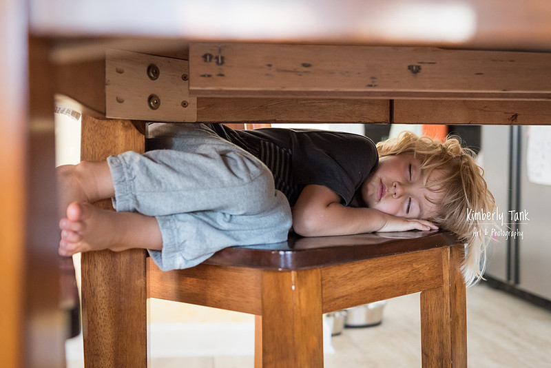 child sleeping on a chair